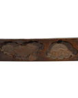 Brown wood rectangular antique Chinese rice mold with carved floral and cloud motifs, close-up.