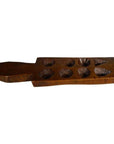 Brown wooden antique Chinese rice mold with floral and geometric patterns, close-up view.