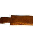 Brown wood antique Chinese rice mold with carved floral and geometric patterns, close-up view.