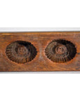 Close-up of an antique Chinese rice mold with scalloped, circular indentations, ceramic material.