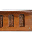 Close-up of a polished brown wooden Antique Chinese Rice Mold with three rectangular floral-carved insets.