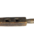 Brown wooden antique Chinese rice mold with two large holes and handle, isolated on white background, close-up.