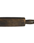 Close-up of rectangular wooden Chinese rice mold with short handle, antique style, resting on a surface.