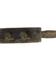 Wooden antique Chinese rice mold with handle, carved two fish shapes, close-up on plain background.