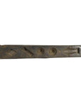 Close-up of antique wooden Chinese rice mold with weathered surface and coin, fish, diamond-shaped cavities.