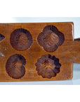 Brown wooden antique Chinese rice mold with geometric eight-shape design, used for traditional cookies or sweets.