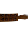 Brown antique Chinese rice mold with geometric eight-shape layout on white background.