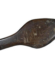 Brown wood antique Chinese rice mold with round motif and braided rim, visible wear, close-up on plain background.