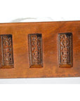 Brown antique Chinese wooden rice mold with five rectangular character cavities, close-up on a plain background.