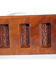Close-up of antique wooden Chinese rice mold showing five rectangular character carvings.