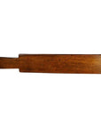 Brown antique Chinese wooden rice mold with five leaf bud impressions and symmetrical floral motif, close-up view.