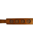 Brown antique Chinese wood rice mold with five floral leaf bud motifs and sturdy left handle, close-up view.