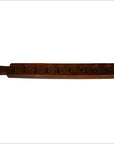Close-up of an antique wooden Chinese rice mold with seven rectangular cavities and mixed carved motifs.