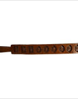 Brown wooden antique Chinese rice mold with seven rectangular motif carvings, close-up on plain background.