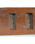 Close-up of brown antique wooden Chinese rice mold with six rectangular motifs and incised characters.