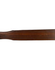 Brown wooden antique Chinese rice mold with six character cavities and curved paddle handle on a white background.