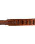 Close-up of antique wooden Chinese rice mold paddle with six character-shaped cavities and a curved form.