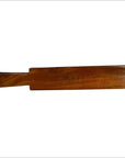 Walnut finish wooden antique Chinese rice mold in solid paddle form, close-up on white background.