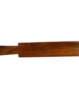 Walnut finish wooden antique Chinese rice mold in solid paddle form, close-up on white background.