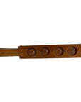 Brown wooden antique Chinese rice mold with four round seal cavities and engraved calligraphy, close-up on white surface.