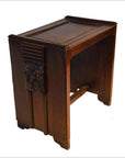 Brown rosewood side table with carved floral and panel details, shown on a white background.