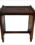 Dark rosewood side table with a rectangular top, raised edges, and sturdy legs with horizontal support.