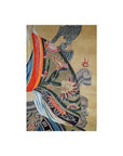 Close-up of colorful dragon and flame robe detail on an antique Chinese scroll painting with decorative background.