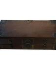 Small antique Chinese wooden chest with metal accents, latch, and two front drawers, close-up view.