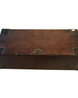 Brown wood antique Chinese chest with metal corner brackets and front keyhole, close-up on rectangular box.