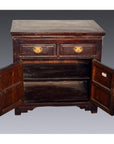 Dark brown lacquered wood Chinese cabinet, two drawers, double doors open to empty interior, close-up view.