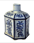 White porcelain sake bottle with blue hand painted floral designs, hexagonal shape, and narrow neck, close-up.