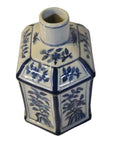Blue and white ceramic hexagonal sake bottle with hand-painted floral designs, narrow neck, top view.