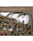 Close-up of brown wood antique Chinese temple carving with ornate floral and scroll patterns, intricate details visible.