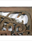 Close-up of brown wood antique Chinese temple carving with ornate floral and scroll patterns, intricate details visible.