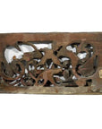 Dark wood rectangular panel with weathered floral and animal carvings, antique finish, rustic appearance.