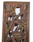 Reddish-brown wood Chinese carving close-up with vertical peony spray, detailed floral and leaf motifs.