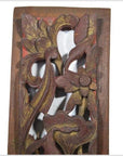 Reddish-brown wood Chinese carving close-up with vertical peony spray, detailed floral and leaf motifs.