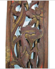 Close-up of antique Chinese vertical peony spray carving in warm natural wood, detailed floral design visible.