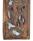 Close-up of antique Chinese wooden carving with vertical peony spray, floral and leaf motifs, faded gold accents.