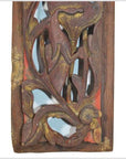 Close-up of antique Chinese wooden carving with vertical peony spray, floral and leaf motifs, faded gold accents.