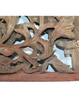 Close-up of aged wood Chinese temple carving with ornate floral details, antique finish visible.