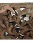 Brown wood antique Chinese temple carving close-up with detailed floral and leaf patterns.