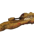 Close-up of weathered, hand-carved antique Chinese temple carving with visible paint on wood.