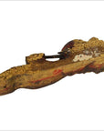 Close-up of weathered, hand-carved antique Chinese temple carving with visible paint on wood.