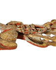 Close-up of a gold and red painted wooden fish carving with decorative accents, antique Chinese temple art.