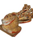 Gold and red carved dragon sculpture with textured, scaly surface, antique Chinese temple art, close-up view.