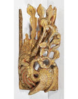 Close-up of antique Chinese temple carving in ornate red and gold wood, with stylized bird and detailed feathers.