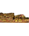 Gilded and red-painted wood dragon carving, antique Chinese temple art, side view on white background.