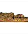 Gilded and red-painted wood dragon carving, antique Chinese temple art, side view on white background.