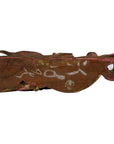 Brown carved and painted wood Chinese temple carving with white markings, hole on one end, natural light setting.